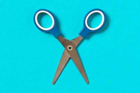 Scissors on blue background. Colored baby scissors