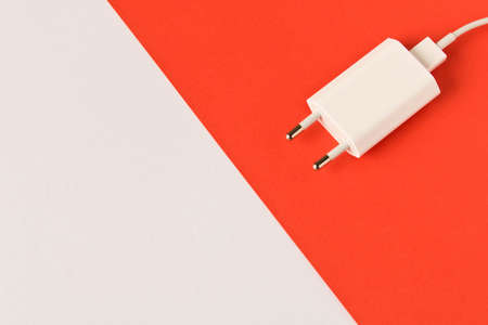 Charger on white red background. Close up. Empty text spaceの写真素材
