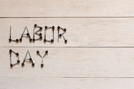 Labor day. Inscription labor day on a light wooden background
