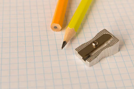 A simple pencil and sharpener on a clean sheet of paper. Selective focusの写真素材