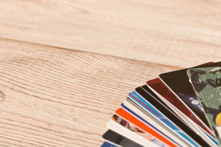 Stack of credit cards . Isolated on wooden background. Empty text spaceの写真素材