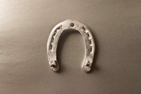 Silver horseshoe on a gray background. An old horseshoe. Close upの写真素材