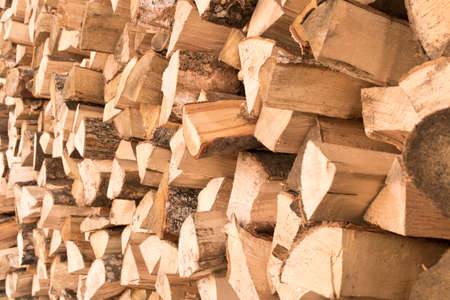 The background texture of a large pile of wood. Close up. Selective focus.
