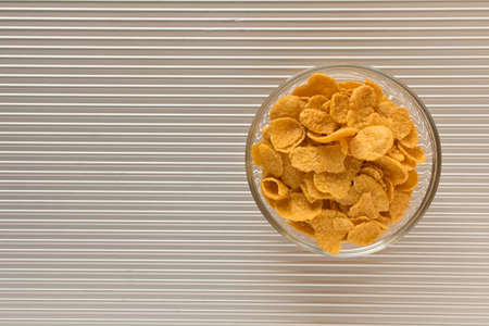 Cornflakes in a plate on a silver background. The view from the top.の写真素材