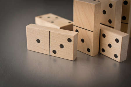 Playing dominoes on a silver background. Leisure games concept. Domino effect