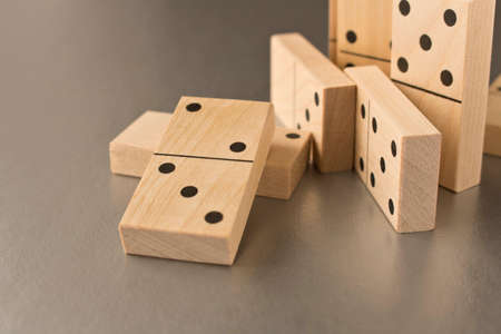 Playing dominoes on a silver background. Leisure games concept. Domino effect