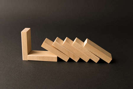 Playing dominoes on a dark background. Leisure games concept. Domino effect. Selective focus