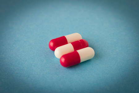 Pills on a blue background. Close up. Selective focus