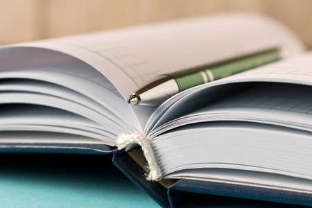 Notepad with a pen on a table. Business suppliesの写真素材