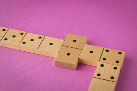 Playing dominoes on a purple background. Leisure games concept. Domino effectの写真素材