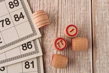Play bingo or Lotto on a wooden table. Concept of Board games