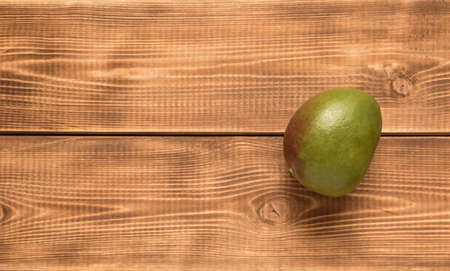 Mango fruit on a wooden table. Close up
