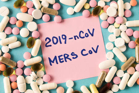 Coronavirus. Sticker with the inscription coronavirus and a scattering of pills on a blue...