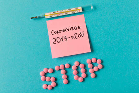 Coronavirus. A thermometer and a sticker that says coronavirus on a blue background. The concept of...