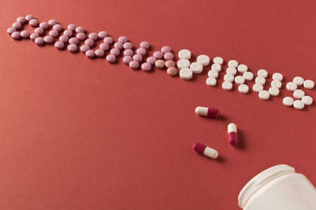 Coronavirus. The inscription coronavirus pills, medical supplies on a red background. The concept of...