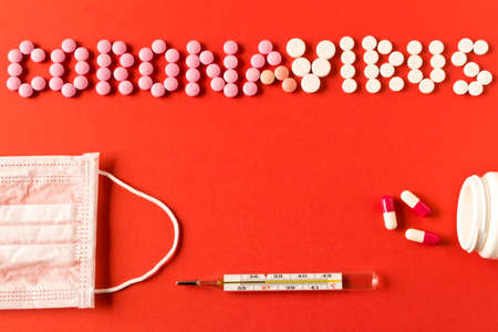 Coronavirus. The inscription coronavirus pills, medical supplies on a red background. The concept of...