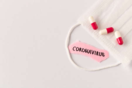 Coronavirus. 2019-nCoV. Protective medical mask and the inscription CORONAVIRUS on a piece of paper...