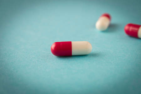 Pills on a blue background. Close up. Selective focus.の写真素材
