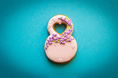 Gingerbread in the form of 8 on a blue background. Concept of international women's dayの写真素材