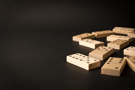 Playing dominoes on a dark background. Leisure games concept. Domino effect. Selective focusの写真素材