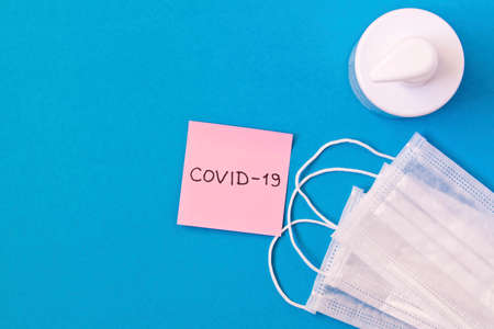 CORONAVIRUS. Covid-19 sticker, protective medical masks, hand sanitizer gel. Concept of prevention of coronavirusの写真素材