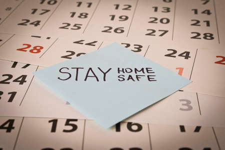 CORONAVIRUS. A sticker with the word STAY HOME on the calendar sheets. The concept of quarantine. Selective focusの写真素材
