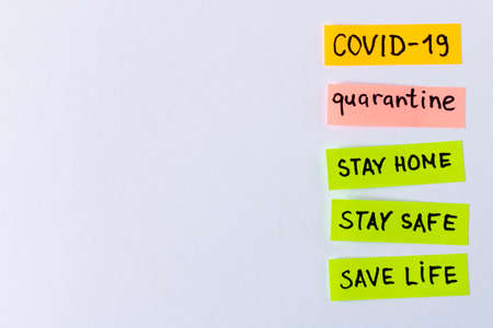 CORONAVIRUS. Stickers with the words COVID-19, quarantine on a light background. Close up. Selective...