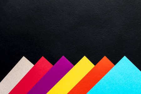 Multi-colored abstract geometric background. Colored sheets of paper on a black background. Trending colors 2020の写真素材