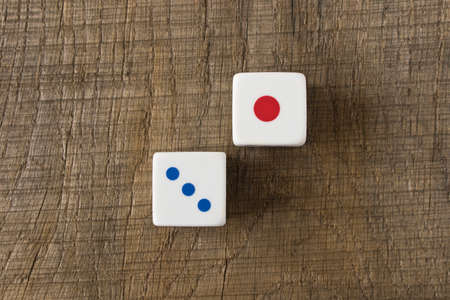 Dice on an old wooden table. Close up. The concept of luck in gambling