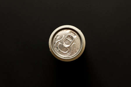A chilled can of beer on a dark background. The view from the top. Close up