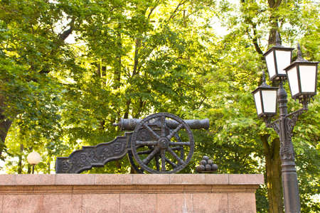An old cannon with balls in the Park