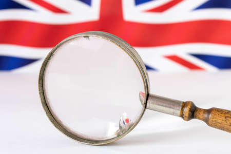 Old magnifying glass on the background of the British Union flag