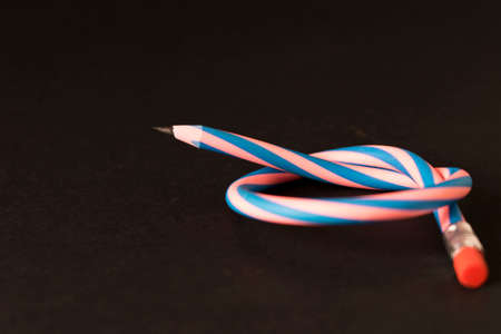 Flexible pencil on a dark background. Selective focus