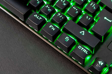 Black gaming keyboard with backlight. Close up. Selective focus