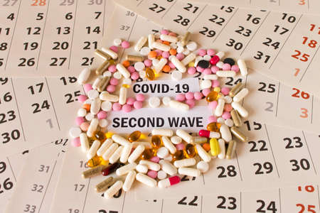 CORONAVIRUS. COVID-19. A pile of pills on the calendar. The concept of protection against viruses. Second waveの写真素材