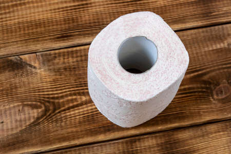 A roll of toilet paper on a wooden table. Close upの写真素材
