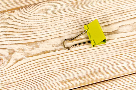 Office clips on a wooden table. Close-up