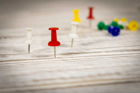 Multicolored push pins on the wooden table. Close up. Selective focusの写真素材