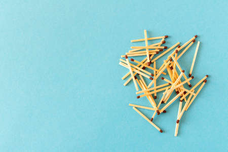 Lots of matches on a blue background. The concept of chaos and order. Selective focusの写真素材