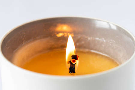 A burning candle on a light background. Close-up. Selective focusの写真素材