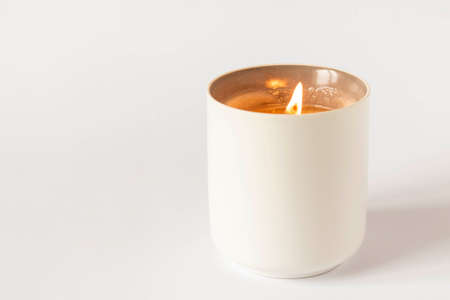 A burning candle on a light background. Close-up. Selective focusの写真素材
