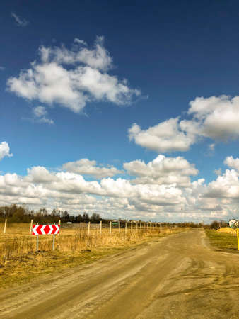 A country road and a sky with clouds. Rural landscapeの写真素材