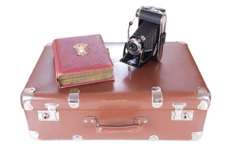 Vintage photography camera with old photoalbum on a suitcase over whiteの写真素材