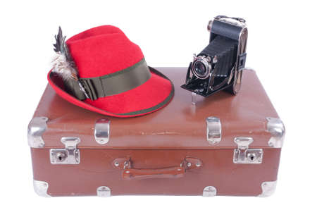 Vintage photography camera with traditional Bavarian hat with feathers over whiteの写真素材