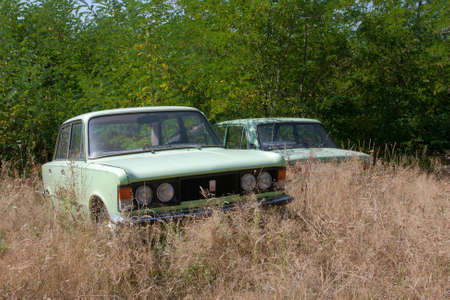 Old abandoned car in the grass 