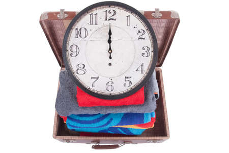 Vintage leather suitcase with clock over white backgroundの写真素材