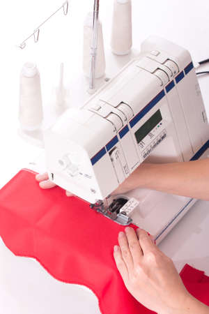 woman sews on the sewing machineの写真素材