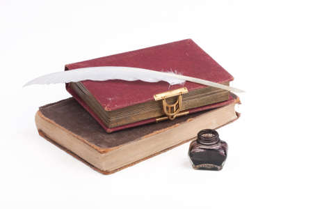 old books and quill feather on a white backgroundの写真素材