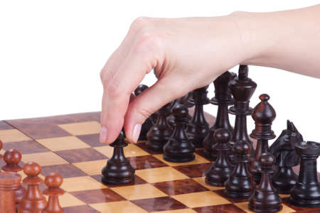 female hand holding a pawn on the chessboard over whiteの写真素材