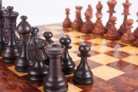 Old Chess board set up to begin a game over whiteの写真素材